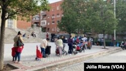 Alrededor de 300 personas acuden a la Plaza San Amaro, en Madrid, para recibir alimentos y productos para los niños. 