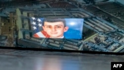 This photo illustration created April 13, 2023, shows convicted intelligence leaker, Air National Guardsman Jack Teixeira, reflected in an image of the Pentagon.