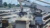 FILE - Grain is offloaded from the Eaubonne bulk carrier ship after it docked in the port of Mombasa, Kenya, Nov. 26, 2022. 