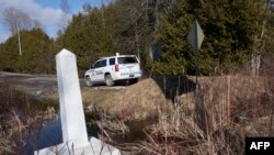 ARCHIVO - El marcador de la frontera entre Estados Unidos y Canadá en Roxham Road, el 26 de febrero de 2017, en Champlain, Nueva York.