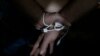 FILE - A suspect is arrested by the Anti-human trafficking division in Mabalacat, Philippines, April 20, 2017.