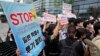 Protesters stand outside the Japanese Embassy in Seoul, South Korea, to denounce the release of treated radioactive water into the sea from the damaged Fukushima nuclear power plant, Aug. 24, 2023.