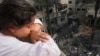 A Palestinian girl looks at the rubble of a building, following an Israeli airstrike, in Beit Lahia in the northern Gaza Strip.