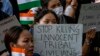 Members of the Kuki tribe, protesting the killing of tribals in their northeastern home state of Manipur, hold Indian flags and placards during a sit-in in New Delhi, India, May 29, 2023.