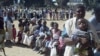 FILE - Abazali bafole lapho okuhlatshwa khona ijekiseni yokuvimba ukumemetheka kweningindi.