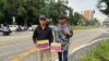 Los migrantes venezolanos Carlos Alexander Briseiro (a la izquierda) y Carlos Millán, sobreviven de la caridad pública en las calles de Ciudad Guatemala, en donde han quedado varados en su ruta hacia EEUU. [Foto: Eugenia Sagastume, VOA]