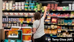 A customer looks at refrigerated items at a Grocery Outlet store in Pleasanton, Calif.,. on Thursday, Sept. 15, 2022.
