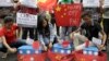 FILE - Filipino student activists set fire mock Chinese ships to protest recent island-building and alleged militarization by China off the disputed Spratlys group of islands in the South China Sea, in Manila, March 3, 2016. 