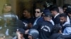 Security officers escort Pakistan's former Prime Minister Imran Khan as he appeared in Islamabad High Court
