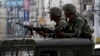 Members of the Philippine Marines hold their weapons aboard a truck as they block a road during fighting between government soldiers and Muslim rebels of Moro National Liberation Front (MNLF) in Zamboanga city in southern Philippines September 15, 2013.