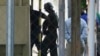 FILE - U.S. Marine Pfc Joseph Scott Pemberton, a suspect in the killing of a transgender Filipino woman, is escorted to his detention inside the compound of the Camp Aguinaldo military headquarters in suburban Quezon city, north of Manila, Philippines.
