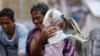 Residents of the slum community of Baseco evacuate to safer grounds at the onslaught of Typhoon Rammasun in Manila, Philippines, July 16, 2014.