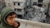 FILE - A Palestinian boy reacts near the site of an Israeli strike on a house in Rafah, Gaza Strip, March 24, 2024. Children in war zones around the world are not receiving lifesaving humanitarian aid, a senior U.N. official said on April 3, 2024.
