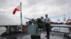 FILE - A member of the Philippine Navy demonstrates one of the guns on board the BRP Gregorio Del Pilar (PF15) warship at Manila's pier, amid tensions with China over the disputed Spratly Islands in the South China Sea, Dec. 17, 2014. 