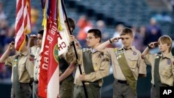 FILE - A color guard of Boy Scouts from the Chief Seattle Council salute during the national anthem before a baseball game between the Seattle Mariners and Houston Astros in Seattle, May 25, 2014.