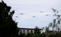 Douglas C-47 and DC-3 aircrafts, known colloquially as "Rosinenbomber" (German for "raisin bomber") and used during the Berlin Airlift, approach former Tempelhof airfield to mark the 70th anniversary of the Berlin Airlift in Germany, June 16, 2019.