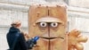 FILE - A journalist takes footage of a statue of "Bernd das Brot" in front of City Hall in Erfurt, Germany, Feb. 4, 2009. "Bernd das Brot" is a talking loaf of bread from a children's TV show. 
