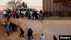 Migrantes que buscan asilo salen del río Bravo después de cruzarlo para entregarse a los agentes de la Patrulla Fronteriza de EEUU en El Paso, Texas, el 17 de diciembre de 2022. REUTERS/José Luis González