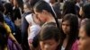 A Typhoon Haiyan survivor kisses her baby as she waits to board her evacuation flight at the airport in Tacloban, Philippines, Nov. 22, 2013. 