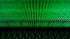 ARCHIVO: Teclado de computadora frente a códigos binarios.

