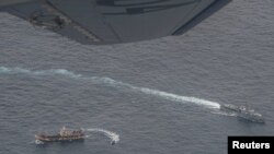 Buques de la Armada ecuatoriana rodean a un barco de pesca, detectado en un corredor internacional que limita con la zona económica exclusiva de las Islas Galápagos, en el Océano Pacífico, el 7 de agosto de 2020.
