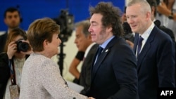 La directora del Fondo Monetario Internacional (FMI), Kristalina Georgieva (izquierda), saluda al presidente argentino Javier Milei antes de una sesión de trabajo sobre Inteligencia Artificial (IA) en la Cumbre del G7.