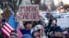 FILE - People protest a funding freeze of federal grants and loans following a push from President Donald Trump to pause federal funding, near the White House in Washington, Jan. 28, 2025.