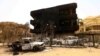 Damaged cars and buildings are seen at the central market in Khartoum North