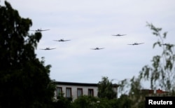 Douglas C-47 and DC-3 aircrafts, also known colloquially as "Rosinenbomber" (German for "raisin bomber") and used during the Berlin Airlift, approach former Tempelhof airfield to mark the 70th anniversary of the Berlin Airlift in Berlin, Germany, June 16, 2019.