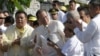 Philippine President Benigno Aquino III, center, is applauded by lawmakers after signing into law the Human Rights Victims Reparation and Recognition Act of 2013, Feb. 25, 2013.