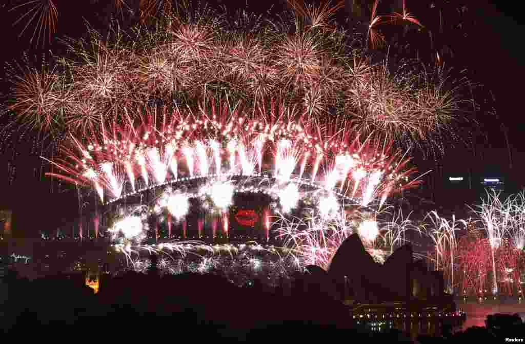 2013年1月1日，为了庆祝新年的到来，澳大利亚悉尼的海港大桥和歌剧院上空燃放的烟花 