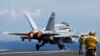 FILE - A U.S. Navy F/A-18 Hornet aircraft takes off during a tour of the USS Nimitz aircraft carrier on patrol in the South China Sea May 23, 2013. 