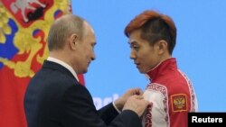 普京2014年2月24日在索契冬奥会上为俄罗斯运动员颁奖（路透社）
