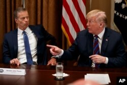 El senador John Thune, republicano por Dakota del Sur, escucha al presidente Donald Trump durante una reunión con gobernadores y legisladores de estados agrícolas en la Casa Blanca. Abril 12 de 2018.