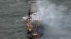Smoke rises from damaged containers on the deck of the MV Solong cargo ship in the North Sea, off the coast of Withernsea, east of England, on March 11, 2025, after it collided with the MV Stena Immaculate tanker on March 10. 
