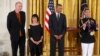 President Barack Obama awards the 2013 National Medal of Arts to Billie Tsien, second from left, and Tod Williams, left, architects, from New York, during a ceremony in the East Room at the White House in Washington, July 28, 2014. 