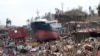 A ship lies on top of damaged homes after it was washed ashore in Tacloban city, Leyte province, central Philippines, Nov. 10, 2013.