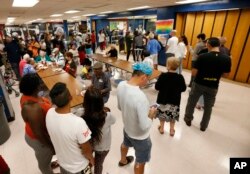 Personas en un refugio de la Cruz Roja en una escuela secundaria del Norte de Miami Beach hace fila para almorzar. Sept. 8, 2017.