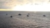 FILE - This handout photo taken from a video released on Apr. 22, 2021 by Russian Defense Ministry Press Service shows, Russian navy ships take part in drills off Crimea in the Black Sea. 