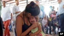 Una mujer venezolana sostiene a una niña en un puesto de salud para migrantes en Cúcuta, en la frontera de Colombia con Venezuela
