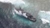 FILE - The USS Guardian, a U.S. Navy minesweeper, is seen at the Vicinity of South Islet in Tubbataha Reefs after it ran aground in Palawan province, west of Manila January 19, 2013 in this handout picture distributed by the Armed Forces of the Philippine