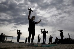Manifestantes frente al palacio presidencial de Planalto, en Brasilia, sostienen en alto cruces en referencia a las 400 mil muertes relacionadas con el covid en Brasil, mientras protestan contra el manejo federal de la pandemia. Mayo 1 de 2021.
