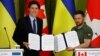 Canadian Prime Minister Trudeau and Ukraine's President Zelenskiy show signed joint declaration during press conference in Kyiv