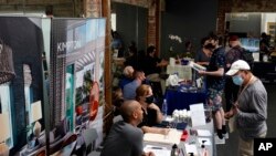 Empleadores atienden a buscadores de empleo durante una feria laboral en Los Ángeles, California, el 22 de septiembre de 2021. 
