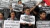 Protesters from the Socialista National Confederation of Labor activist group blow whistles as a part of the noise barrage during a rally over the South China Sea disputes with China, outside the Chinese Consulate in Makati City, Manila, July 10, 2015. 