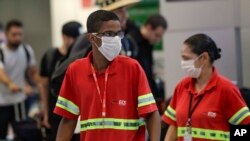 在巴西圣保罗国际机场，工作人员戴着口罩预防新冠病毒传播。（2020年2月26日）