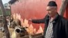 Larbi El Ghazouani, a 55-year-old farmer, tends to sheep he has bred in anticipation of Eid Al-Adha, an annual celebration in which Muslims sacrifice and feast on livestock in Ouled Slama, Morocco, on Feb. 27, 2025.