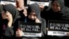 Filipino Muslims display messages during a rally at the Lower House to call for the passage of Bangsamoro Basic Law, or BBL, in Quezon city, northeast of Manila, Tuesday, Feb. 10, 2015.