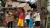 Children hold signs asking for help and food along the highway, after Typhoon Haiyan hit Tabogon town in Cebu Province, central Philippines November 11, 2013.